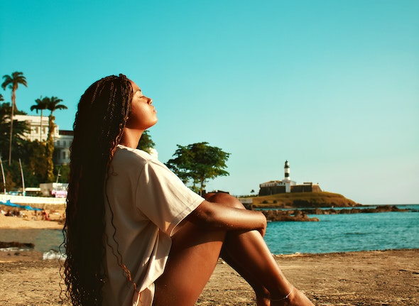 decorative picture of a person relaxing next to the ocean