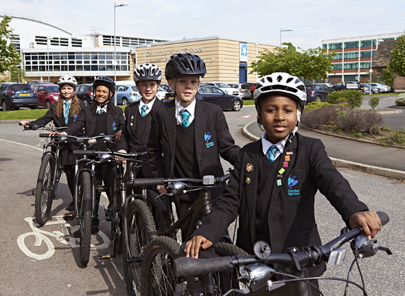 Decorative image of school children on bicycles