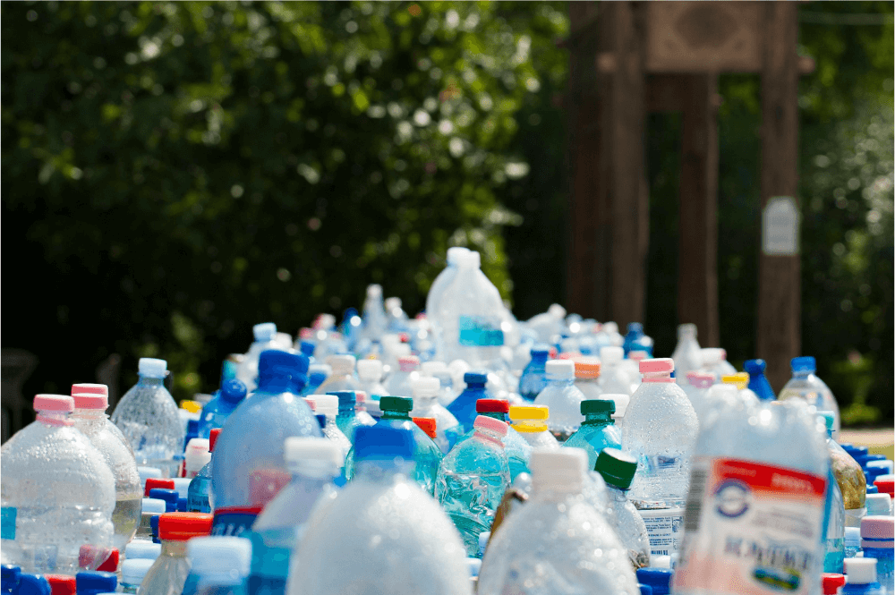 A stack of plastic bottles outside.