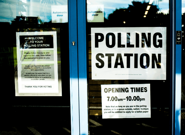 Double doors with a large sign reading "polling station".