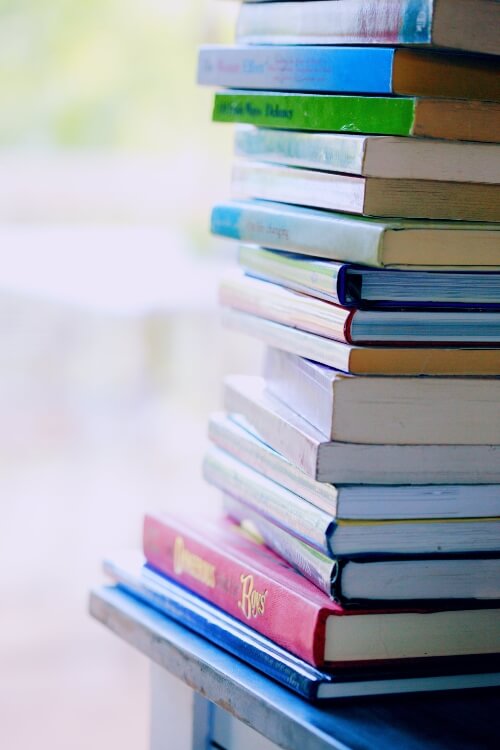 A stack of books all with different coloured spines.