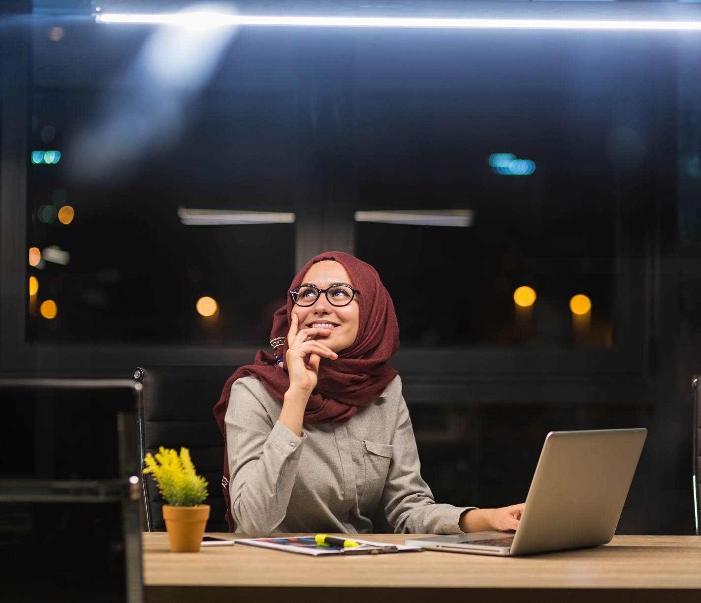 a woman working at night at a desk