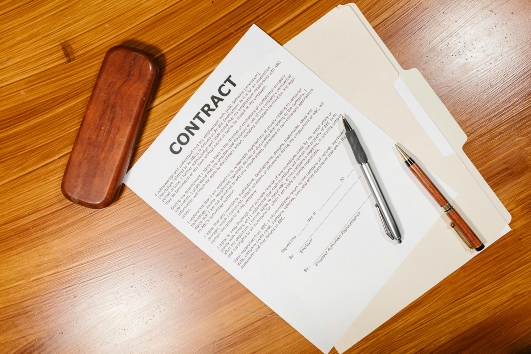 a contract on a wooden desk