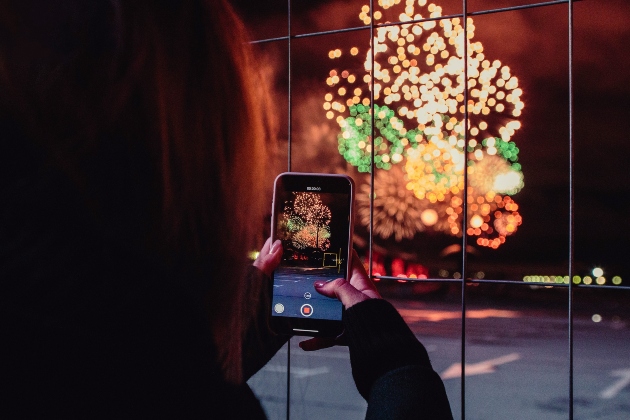 someone taking a photograph of a firework display