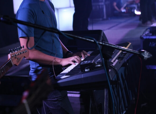 A man playing the piano on stage