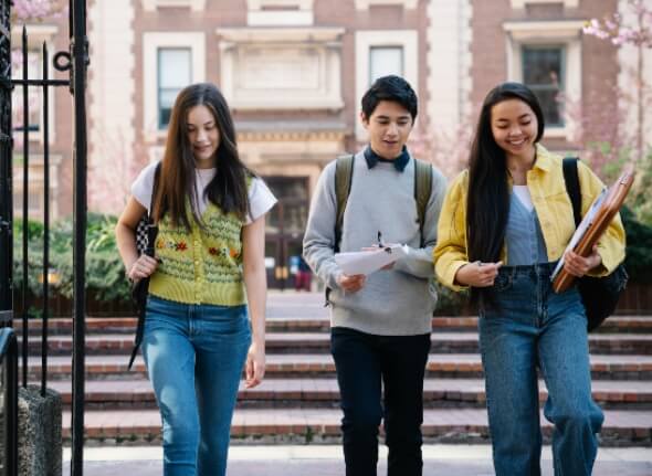 Three students walking together in campus site