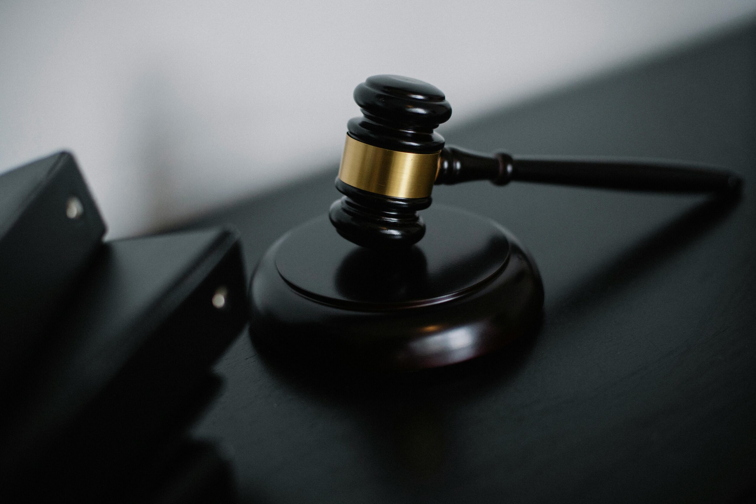 wooden-gavel Black wooden gavel on a desk