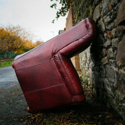 a red armchair on the roadside